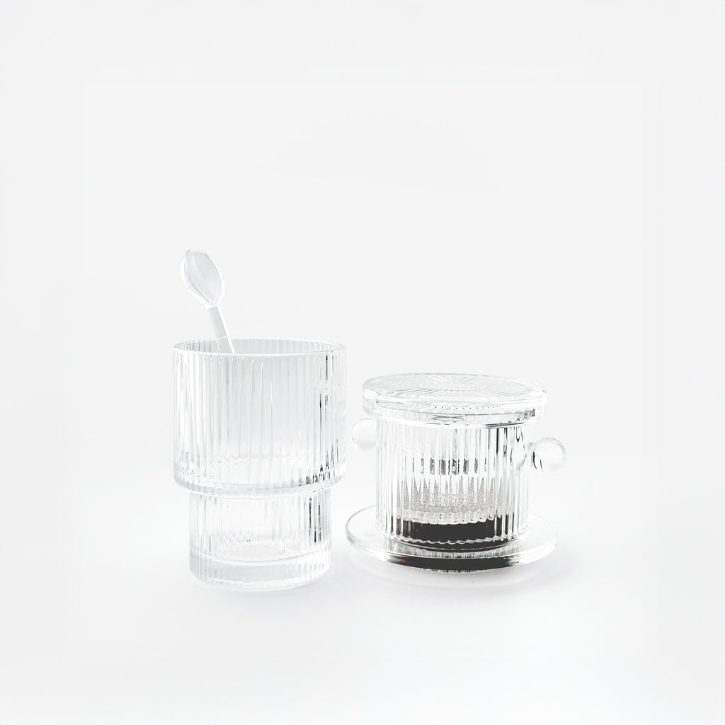 Vietnamese drip coffee brew set with the original glass phin, a reeded double-wall glass, and a matching spoon.